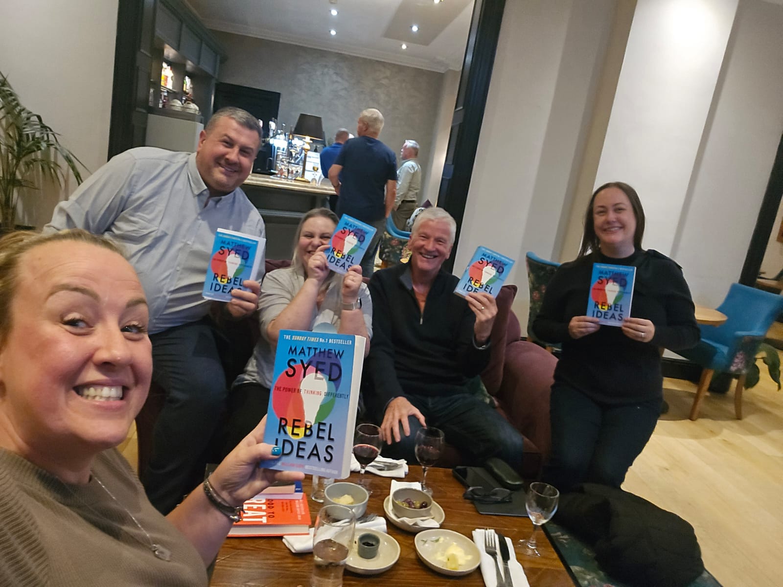 Chester Business Book Club members with copies of Rebel Ideas by Matthew Syed